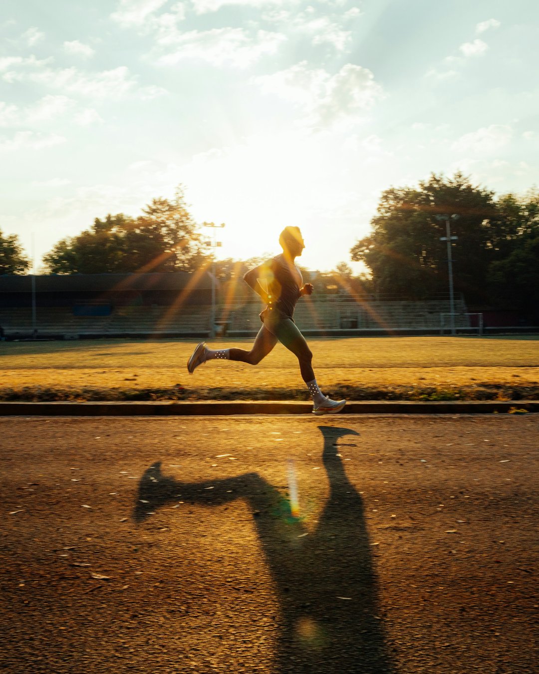 Runner sprinting on a track at sunrise — the goal CarbMeNot helps you reach
